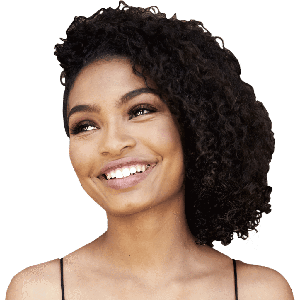 Smiling young woman with curly hair looking off to the side against a white background.