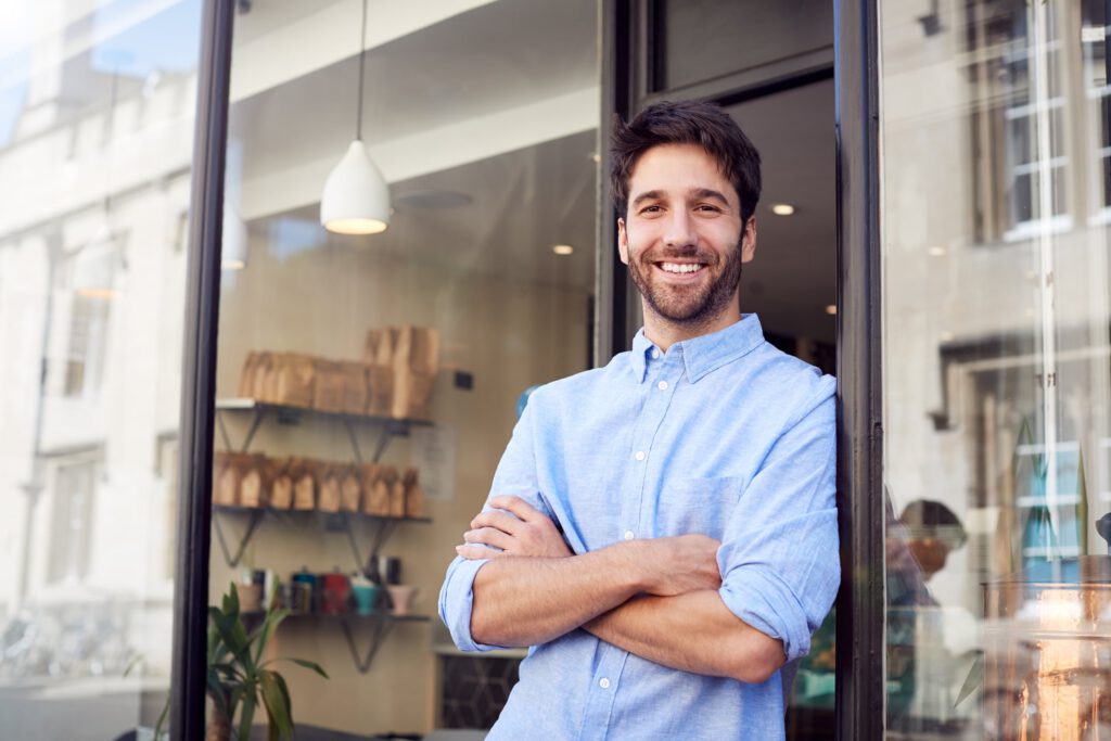 Confident man standing outside a local business as part of community recovery and support