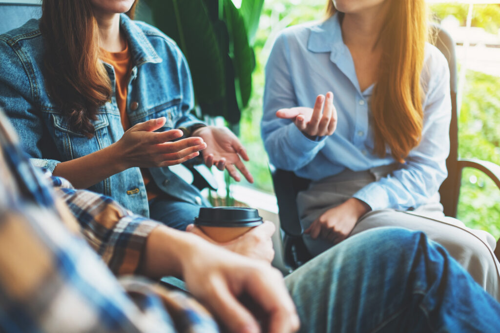 People talk during a peer support group session in a counseling setting.