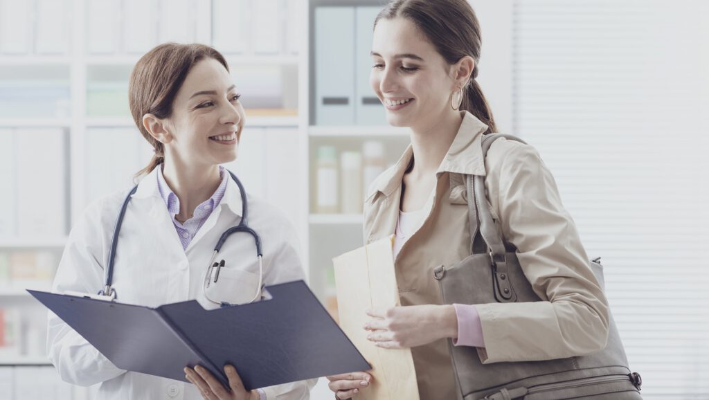 Nurse showing medical records and checking on a patient with warmth and attentiveness during acute care