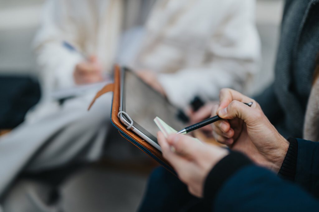 Therapist taking clinical notes on tablet during a behavioral health session