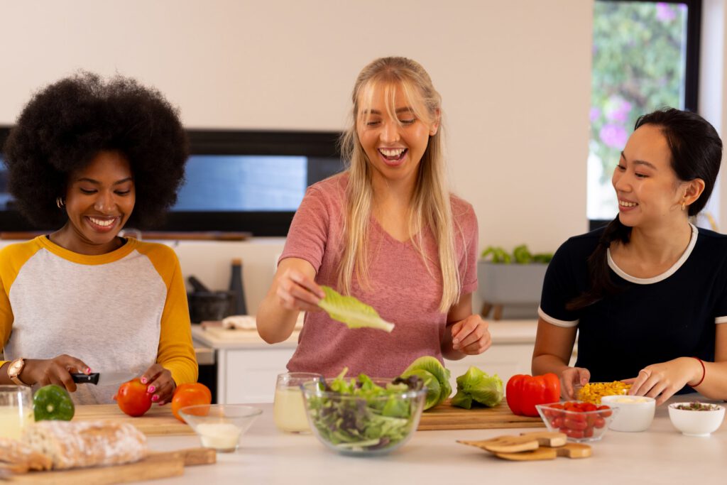 Women in a sober living recovery house cooking a healthy meal together and building community