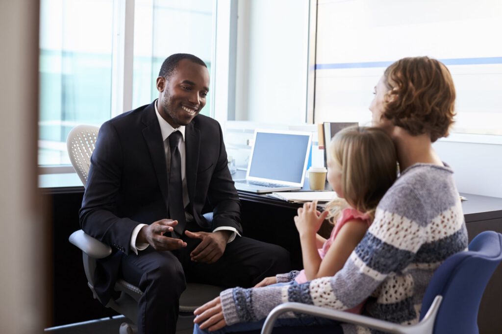 Clinician speaks with a mother and her young daughter during an office visit